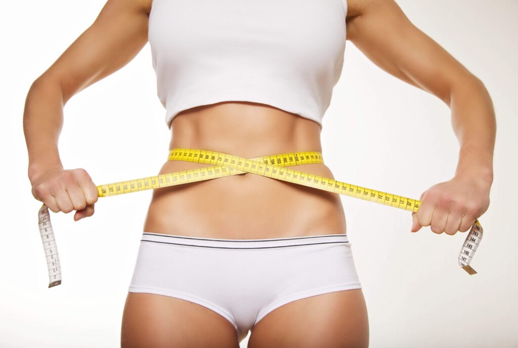 weight lose Fit woman in underwear with measure tape